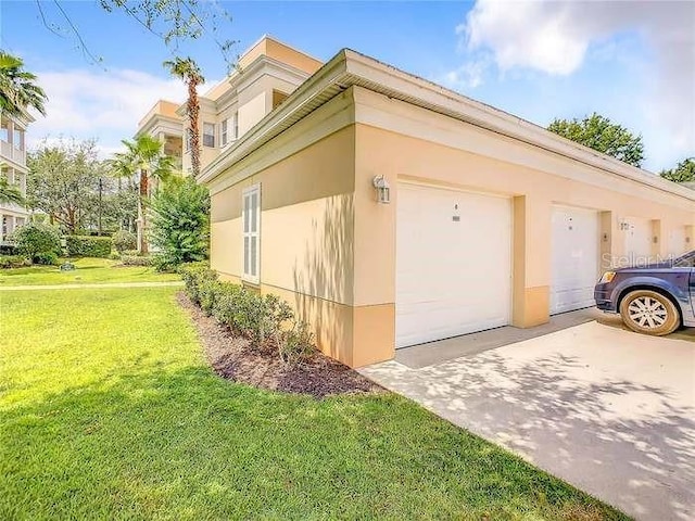 view of side of home with a yard and a garage