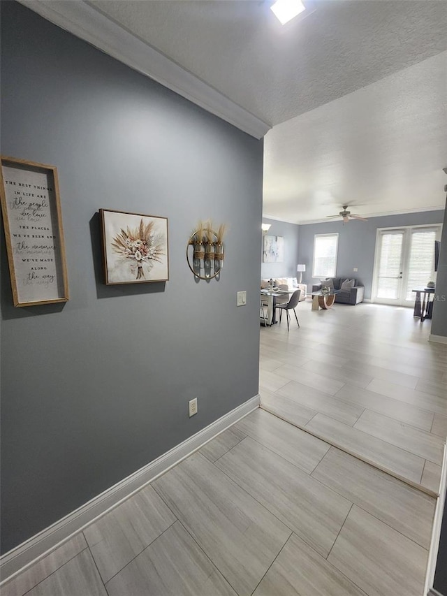 corridor featuring french doors and light hardwood / wood-style floors