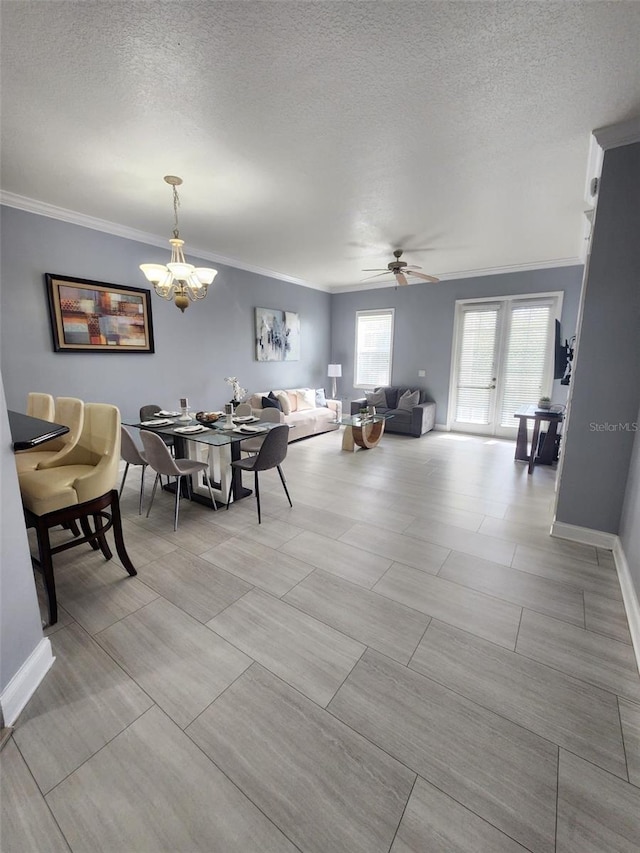 dining space featuring french doors, ceiling fan with notable chandelier, a textured ceiling, and ornamental molding