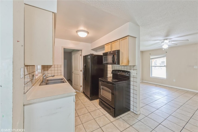 kitchen featuring decorative backsplash, light tile patterned floors, black appliances, ceiling fan, and sink