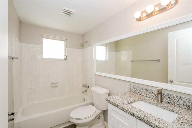 full bathroom featuring tiled shower / bath combo, vanity, and toilet