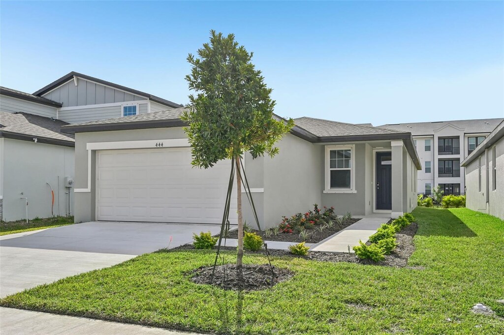 444 Lazy Shore Dr, Nokomis, FL 34275 - view of front of home featuring a front yard and a garage