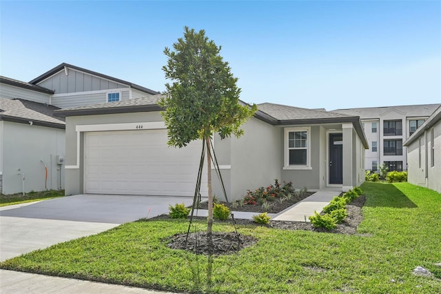 view of front of home featuring a front yard and a garage