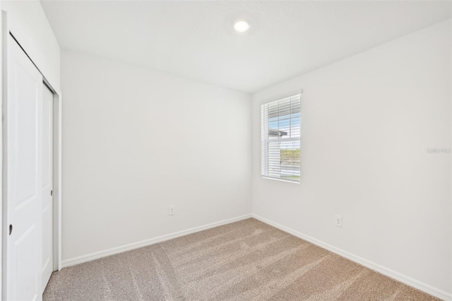 unfurnished bedroom featuring carpet and a closet