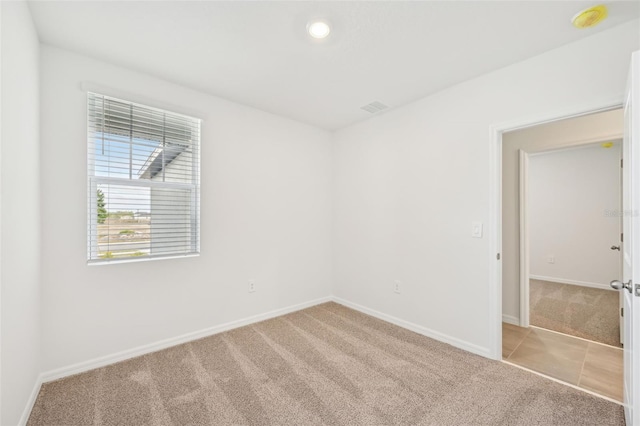 empty room featuring light carpet