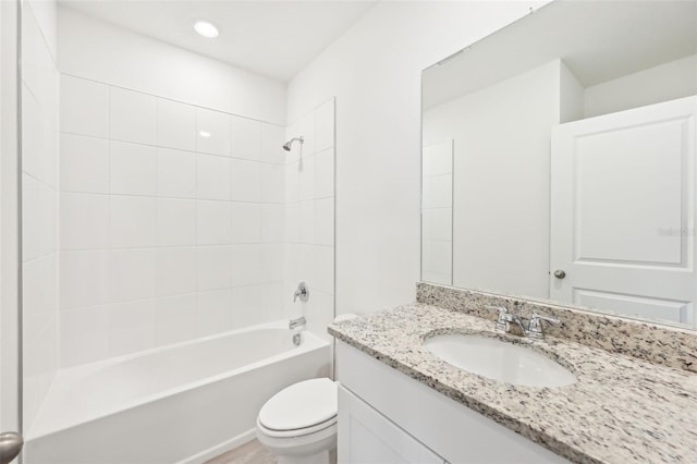 full bathroom with vanity, toilet, and tiled shower / bath