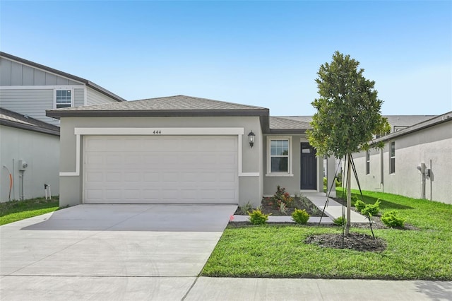 view of front of house with a front lawn and a garage