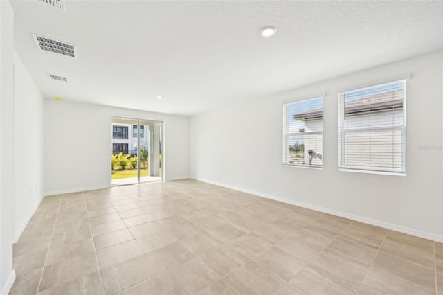 unfurnished room featuring light tile patterned floors