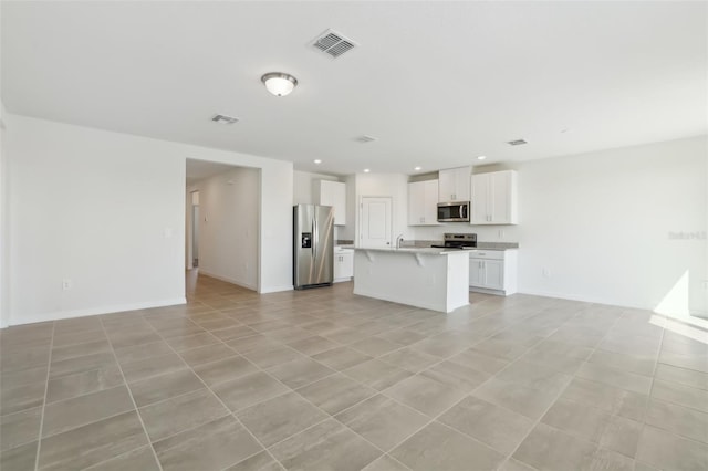 unfurnished living room with recessed lighting, visible vents, baseboards, and a sink