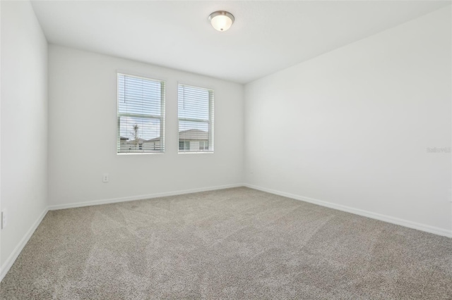 empty room with baseboards and carpet floors