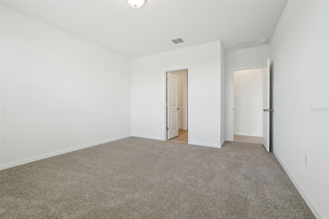 unfurnished bedroom with baseboards, visible vents, and light carpet