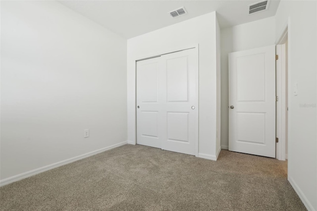 unfurnished bedroom with visible vents, carpet flooring, and baseboards