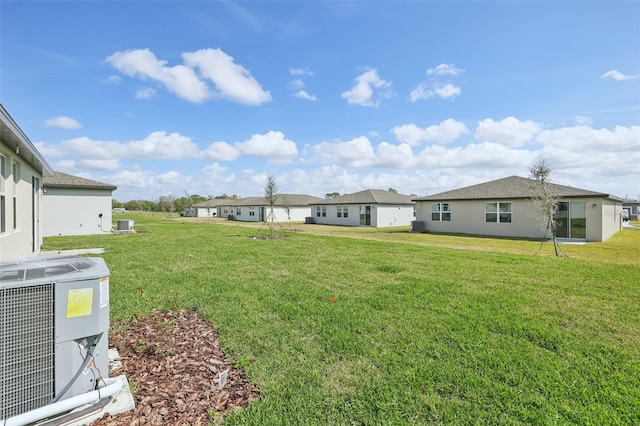 view of yard with a residential view and central AC