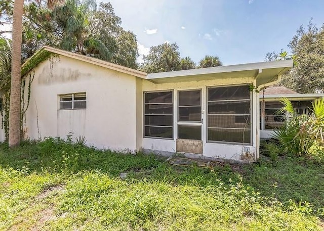 view of side of property with stucco siding