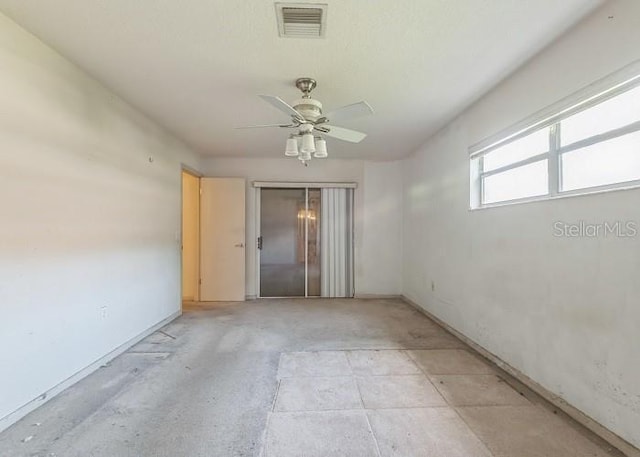 spare room with ceiling fan and visible vents