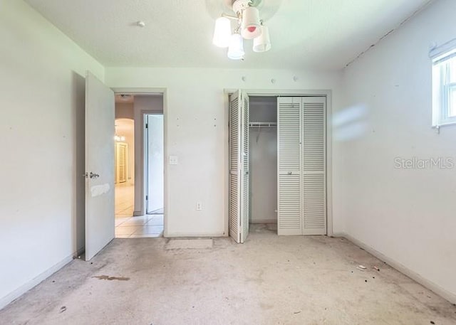 unfurnished bedroom with baseboards and a closet