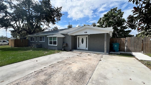 ranch-style home with a front yard and cooling unit