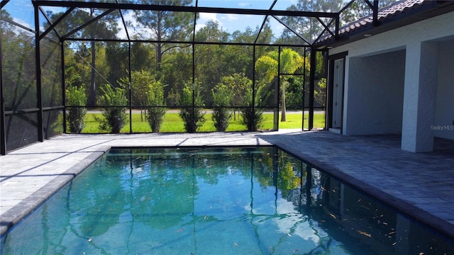 view of pool with a patio and a lanai