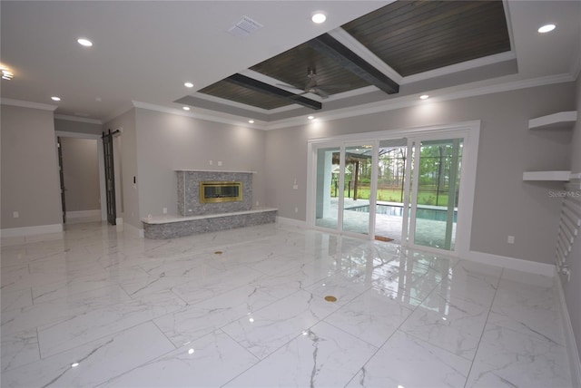 unfurnished living room with ceiling fan, beamed ceiling, ornamental molding, and a high end fireplace