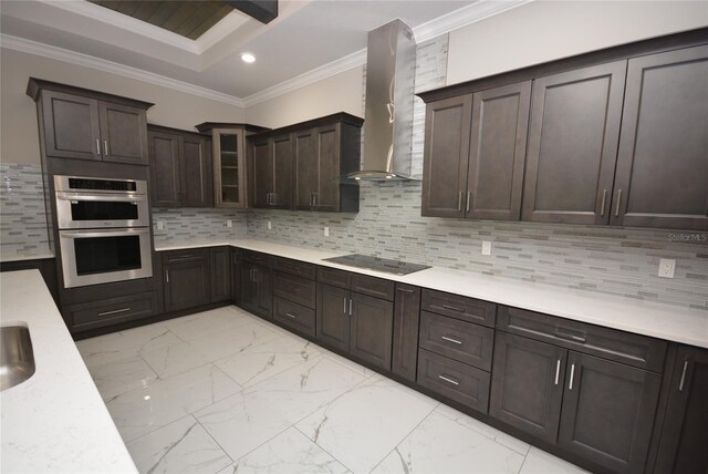 kitchen featuring black electric cooktop, tasteful backsplash, stainless steel double oven, wall chimney range hood, and ornamental molding