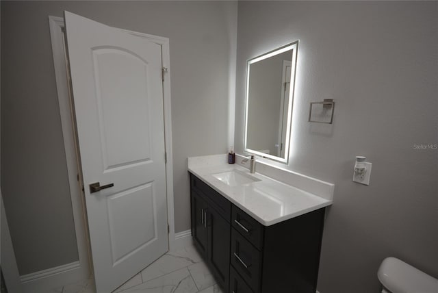 bathroom with vanity and toilet