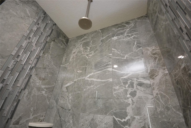 details with walk in shower and a textured ceiling