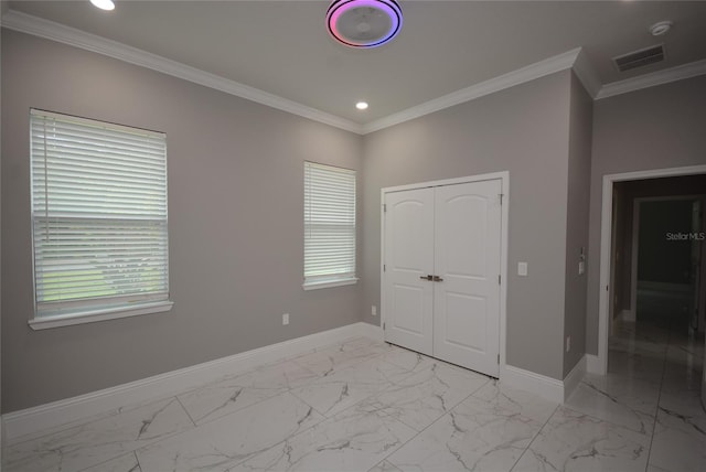 unfurnished bedroom with a closet and ornamental molding