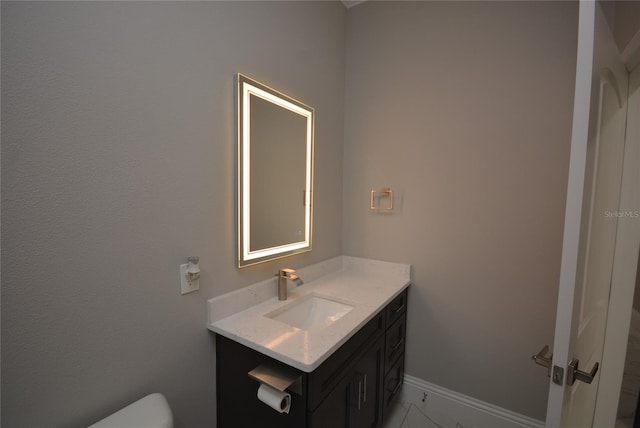 bathroom featuring toilet and vanity