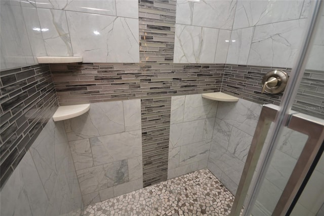 bathroom with tile walls and walk in shower