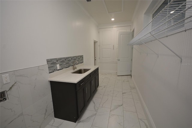 kitchen with crown molding and sink