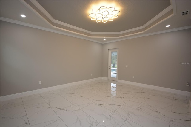 unfurnished room featuring crown molding and a tray ceiling