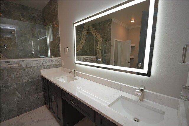 bathroom featuring ornamental molding, vanity, and tiled shower