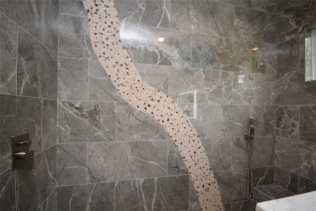 bathroom with a tile shower