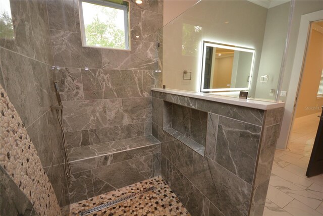 bathroom with tiled shower