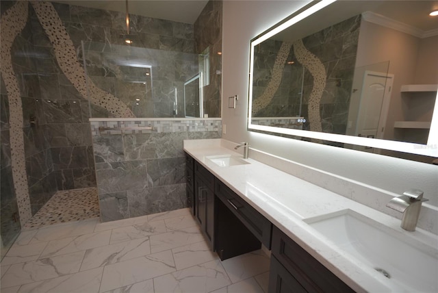 bathroom with ornamental molding, a tile shower, and vanity