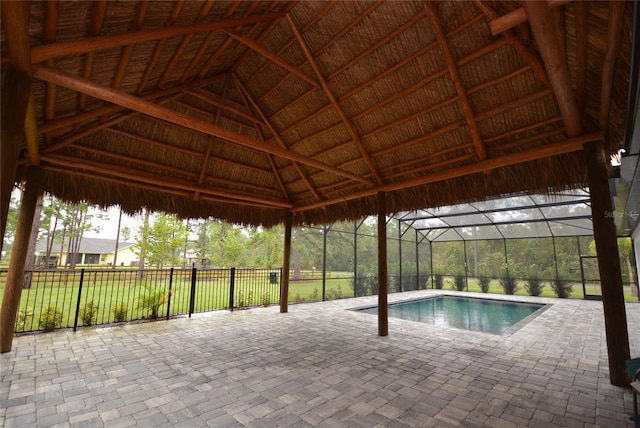 view of pool with a gazebo, a lawn, a patio area, and a lanai