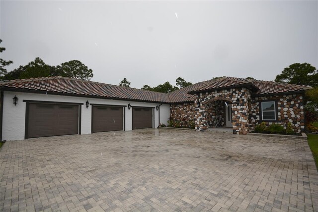 mediterranean / spanish-style home featuring a garage