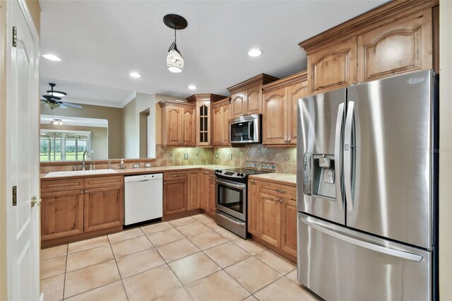 kitchen featuring decorative backsplash, stainless steel appliances, sink, light tile patterned flooring, and crown molding