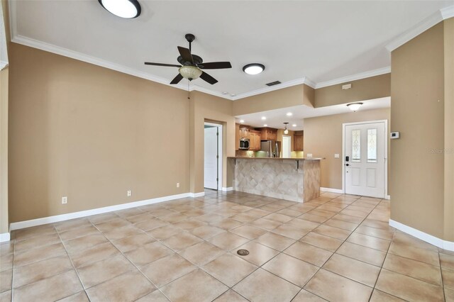 unfurnished living room featuring ornamental molding, light tile patterned floors, and ceiling fan