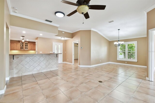 spare room featuring light tile patterned flooring, ceiling fan with notable chandelier, and crown molding