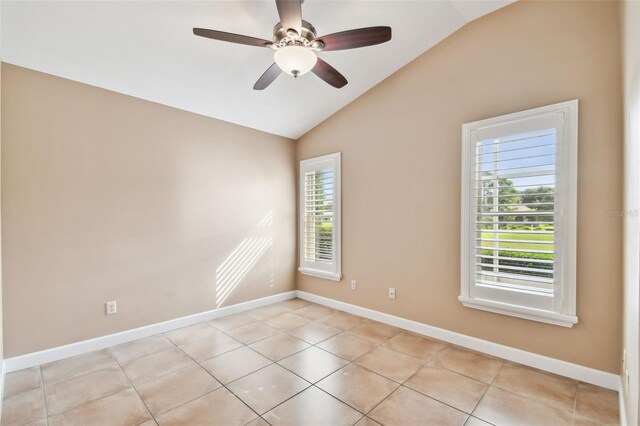 tiled empty room with lofted ceiling and ceiling fan