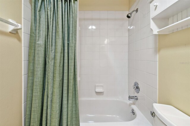 bathroom featuring shower / bath combination with curtain and toilet