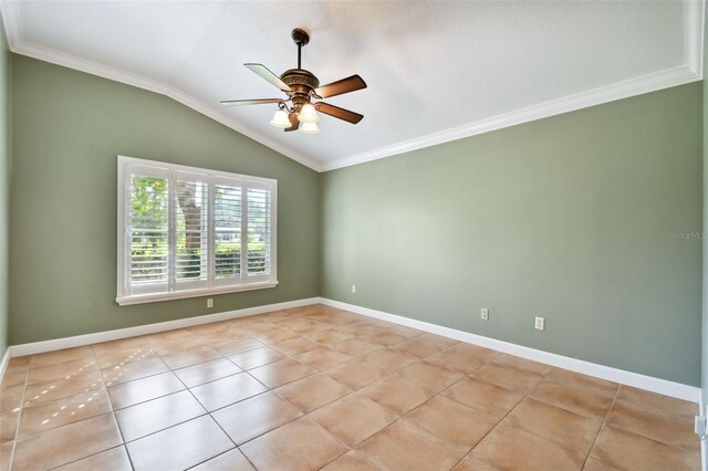 empty room featuring crown molding, vaulted ceiling, light tile patterned floors, and ceiling fan