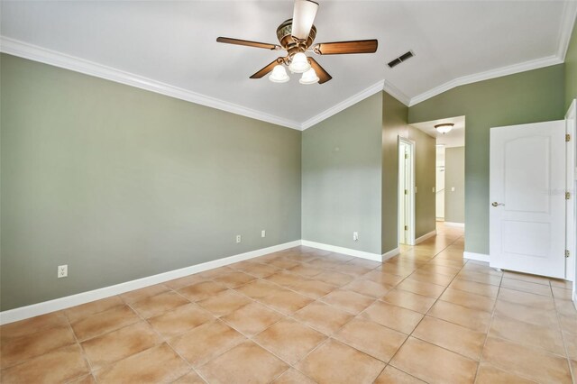 empty room with ceiling fan, ornamental molding, light tile patterned floors, and vaulted ceiling