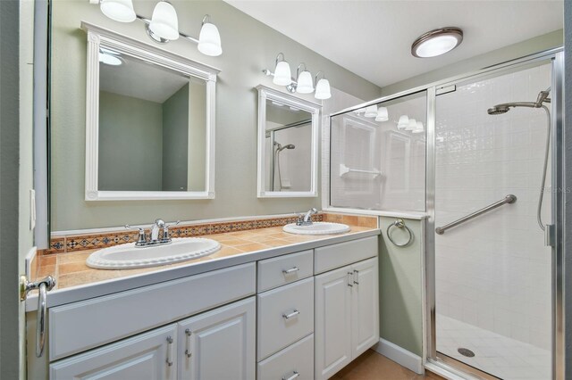 bathroom with vanity and a shower with shower door