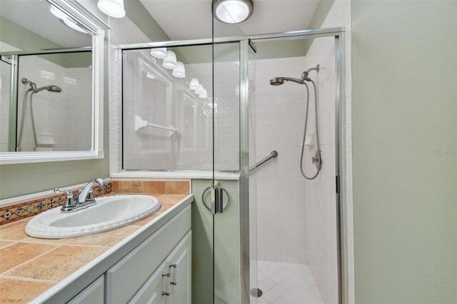 bathroom with vanity and a shower with door