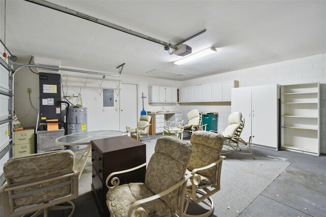 garage with electric panel, a garage door opener, and water heater