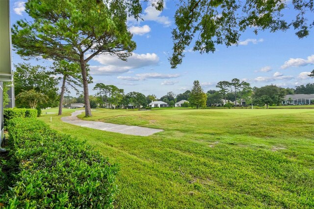 view of property's community featuring a yard