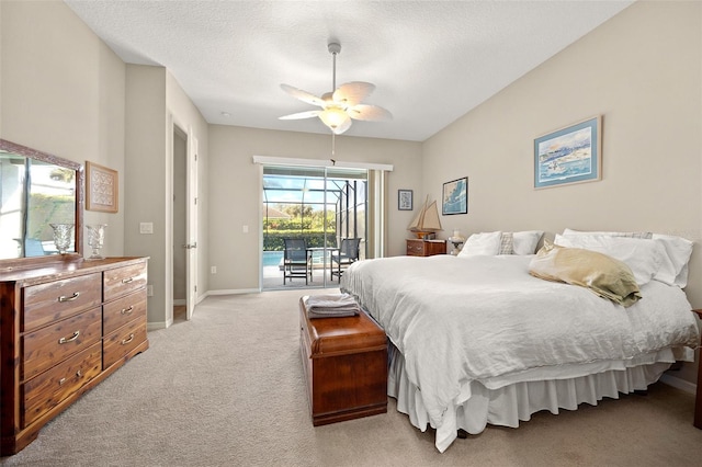 carpeted bedroom featuring a textured ceiling, ceiling fan, and access to exterior