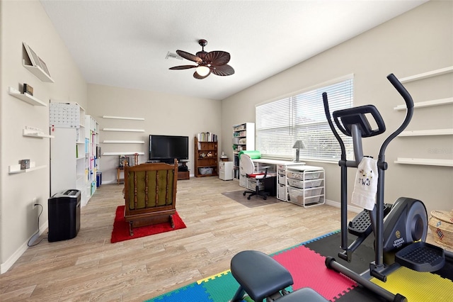 workout area with light hardwood / wood-style floors and ceiling fan